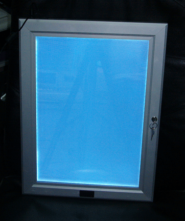 The same framed mirror with the LED light on even though no advert is inserted behind the mirror